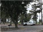 A truck and trailer in a gravel RV site at BOOTHEEL RV PARK & EVENT CENTER - thumbnail