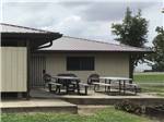 A couple of picnic tables outside of the main building at BOOTHEEL RV PARK & EVENT CENTER - thumbnail