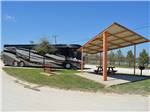 Site with RV and covered picnic table at ABILENE RV PARK - thumbnail