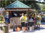 Kids in life vests waiting to get kayaks  at MYRTLE BEACH TRAVEL PARK - thumbnail