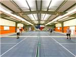 People playing at indoor tennis courts at ENCORE SUNSHINE - thumbnail