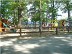 Playground with swing set at BIG OAKS FAMILY CAMPGROUND - thumbnail