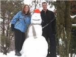 Couple with snowman at FOUR SEASONS CAMPGROUNDS - thumbnail
