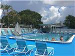 Swimming pool with outdoor seating at PARADISE ISLAND RV RESORT - thumbnail