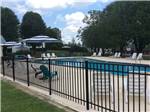 Pool with chairs and shade areas at CHATTANOOGA HOLIDAY TRAVEL PARK - thumbnail