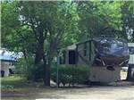 5th wheel parked under shade trees at TAKE-IT-EASY RV RESORT - thumbnail