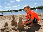 Kid playing on the beach at FISHERMAN'S COVE TENT & TRAILER PARK - thumbnail
