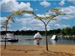A young boy walking to the floating devices at FISHERMAN'S COVE TENT & TRAILER PARK - thumbnail