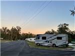 A motorhome and trailers parked in sites at JOHNSTON SPRINGS RV CAMPGROUND & STORAGE - thumbnail
