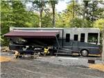 A motorhome in a gravel RV site at AUGUSTA-WEST LAKESIDE KAMPGROUND - thumbnail