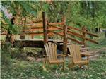 Chairs next to bridge leading to cottages at LAKE PARK CAMPGROUND & COTTAGES - thumbnail