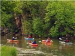 A group of people kayaking on water at LAKE PARK CAMPGROUND & COTTAGES - thumbnail