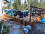 Raised wooden patio with chairs at CARIBOU RV PARK - thumbnail