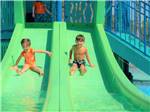 A couple of kids on a waterslide at LAKEWOOD CAMPING RESORT - thumbnail