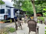 Motorhome parked in site next to chairs and fire pit at HUNGRY HORSE FAMILY CAMPGROUND - thumbnail