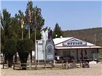 The front office with flags at TOMBSTONE RV PARK - thumbnail