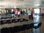 People standing in the rec hall at SEVEN SPRINGS TRAVEL PARK - thumbnail