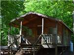 A wooden cottage surrounded by trees at PINCH POND FAMILY CAMPGROUND - thumbnail