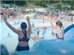 A couple of girls going down the slide at HARTT ISLAND RV RESORT & WATERPARK - thumbnail