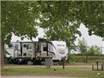 A motorhome in a campsite at GLOWING EMBERS RV PARK & TRAVEL CENTRE - thumbnail