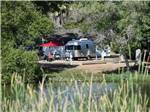 A trailer in an RV site along the water at SANTEE LAKES RECREATION PRESERVE - thumbnail