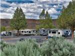 A group of RV sites with mountains in the background at CROOKED RIVER RANCH RV PARK - thumbnail