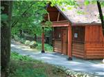 Rustic cabin style building in the trees at KING PHILLIPS CAMPGROUND - thumbnail