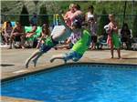 Two kids diving in pool at KING PHILLIPS CAMPGROUND - thumbnail