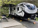 A travel trailer in a back in RV site at TWIN CREEK RV RESORT - thumbnail