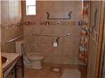 Bathroom with tiled walls and floor at MINGO RV PARK - thumbnail