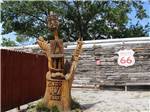Tree carved with Mingo RV insignia at MINGO RV PARK - thumbnail