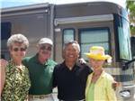 Two couples standing in front of a motorhome at RINCON COUNTRY WEST RV RESORT - thumbnail