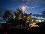 An travel trailer at dusk at SHADY ACRES RV PARK - thumbnail