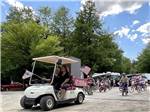 A bunch of kids riding their bikes in a parade at KATAHDIN SHADOWS CAMPGROUND & CABINS - thumbnail