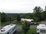 Big rigs in paved sites on grass at ASHEVILLE BEAR CREEK RV PARK - thumbnail
