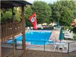 View of the swimming pool and deck area at ASHEVILLE BEAR CREEK RV PARK - thumbnail