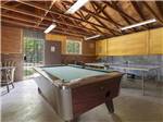 A pool table and ping pong table in the rec room at BAR M RESORT & CAMPGROUND - thumbnail