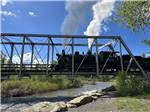 A black train crossing over the river nearby at RIO CHAMA RV PARK - thumbnail