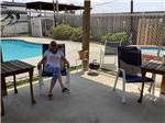 A lady in a sitting area next to the pool at JUDE TRAVEL PARK OF NEW ORLEANS - thumbnail