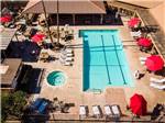 Aerial view over pool and spa with red umbrellas at RIO BEND RV & GOLF RESORT - thumbnail