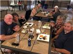 People sitting at a table and eating at RIO BEND RV & GOLF RESORT - thumbnail