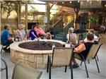 People sitting around a fire pit watching live music at RIO BEND RV & GOLF RESORT - thumbnail