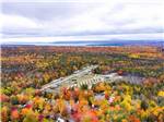 An aerial view of the campground surrounded by colorful fall trees at TIMBERLAND ACRES RV PARK - thumbnail