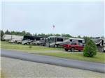 Paved road and a row of big rigs at TIMBERLAND ACRES RV PARK - thumbnail