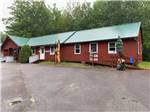 Red building with wood sculptures at TIMBERLAND ACRES RV PARK - thumbnail