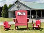 One big red chair and two small red chairs at TIMBERLAND ACRES RV PARK - thumbnail