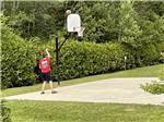 A young man playing basketball at TIMBERLAND ACRES RV PARK - thumbnail
