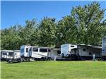 A row of trailers next to the grass at RIVERSIDE RV PARK & RESORT - thumbnail