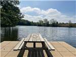 A picnic bench on the dock at CAMP LAKEWOOD CAMPGROUND - thumbnail