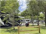 A motorcycle next to a motorhome at STAGECOACH RV PARK - thumbnail